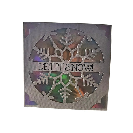 Decorative card with snowflake design and 'LET IT SNOW!' text on a white background